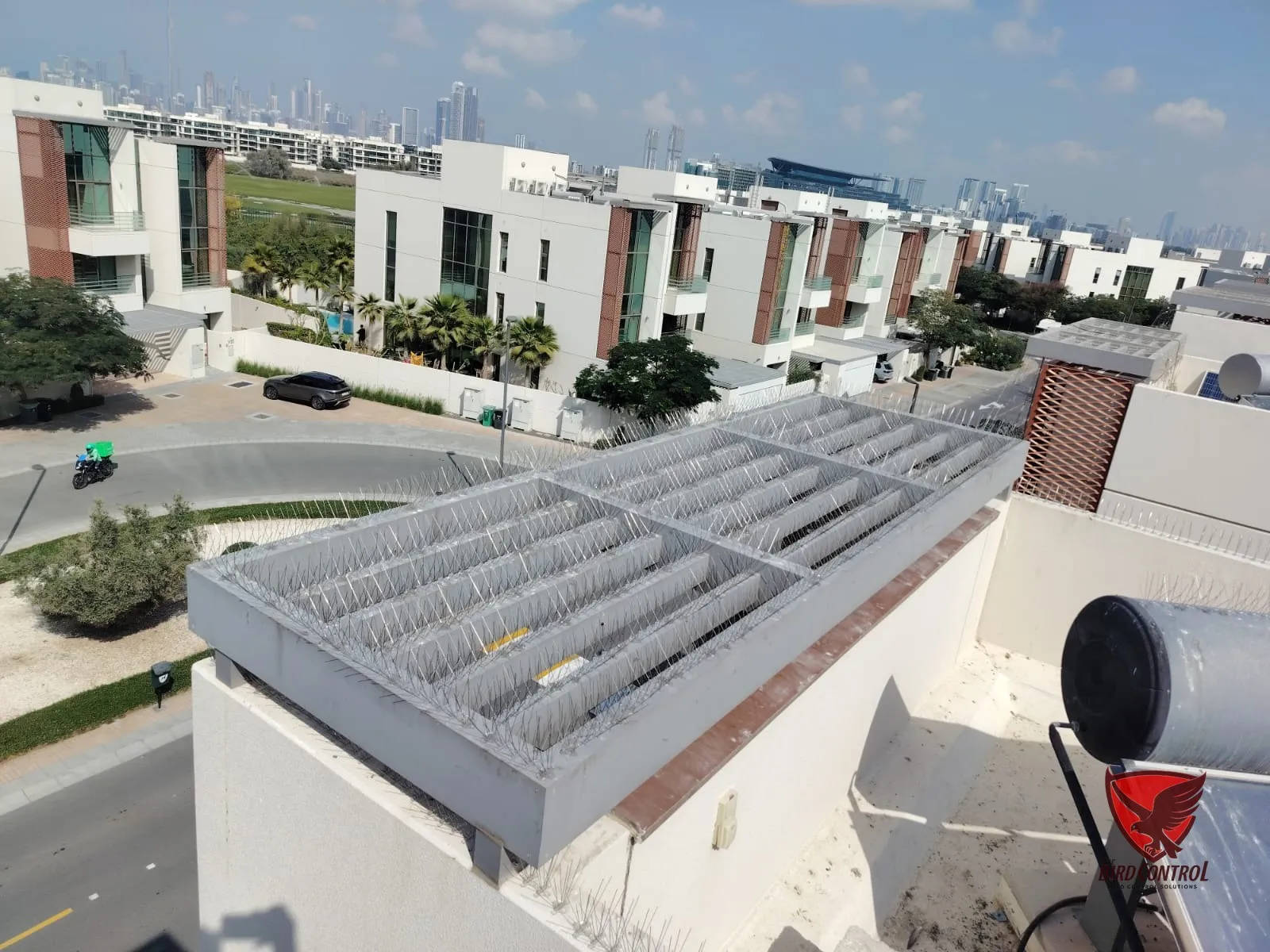 Stainless steel bird spikes installed on villa rooftop parapet, Dubai